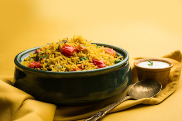 Tomato Rice also known as Tamatar Pilaf/pulav made using basmati rice, served in a bowl. selective focus