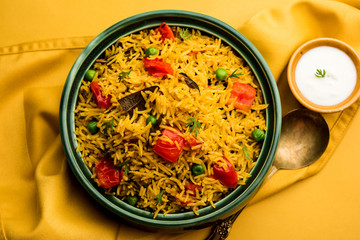 Tomato Rice also known as Tamatar Pilaf/pulav made using basmati rice, served in a bowl. selective focus