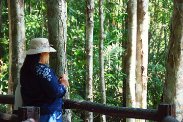 Beautiful Woman taking photo nature in Thailand.