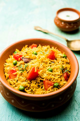 Tomato Rice also known as Tamatar Pilaf/pulav made using basmati rice, served in a bowl. selective focus
