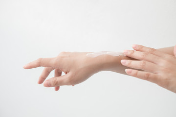 Closeup of beautiful female hands holding hands and applying a moisturizer. Beauty woman's hand applying cream.