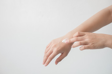 Fototapeta na wymiar Closeup of beautiful female hands holding hands and applying a moisturizer. Beauty woman's hand applying cream.