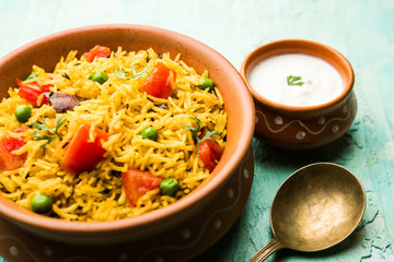 Tomato Rice also known as Tamatar Pilaf/pulav made using basmati rice, served in a bowl. selective focus