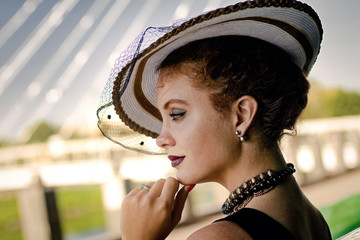 Young woman in a hat with a veil