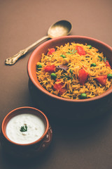 Tomato  pulav/Pilaf made using basmati rice, served in a bowl. selective focus