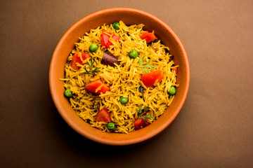 Tomato  pulav/Pilaf made using basmati rice, served in a bowl. selective focus
