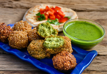 Close up of fresh falafel balls with pesto sause and   pita bread. Selective focus.