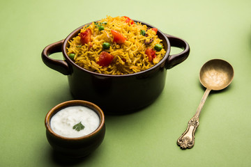 Tomato  pulav/Pilaf made using basmati rice, served in a bowl. selective focus