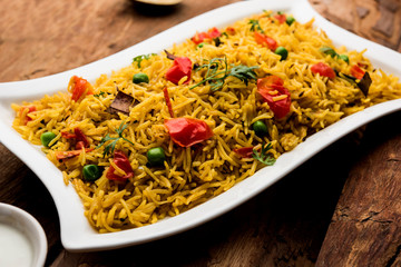 Tomato  pulav/Pilaf made using basmati rice, served in a bowl. selective focus