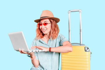happy girl of the Asian appearance with a laptop and a suitcase to checking email or looking and...
