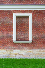 red brick wall with brick window