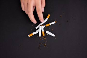 Quit smoking,hand hold cigarette destroy isolated on black background.