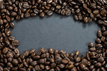 Brown roasted coffee beans, seed on dark background.