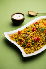 Tomato  pulav/Pilaf made using basmati rice, served in a bowl. selective focus