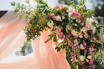 Coziness and style. Modern event design. Lounge zone and european traditional wedding ceremony decoration outdoors in the restaurant before the reception.