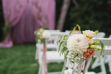 Coziness and style. Modern event design. Lounge zone and european traditional wedding ceremony decoration outdoors in the restaurant before the reception.