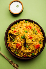 Tomato  pulav/Pilaf made using basmati rice, served in a bowl. selective focus