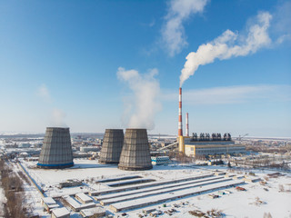 Landscape of smoking chimneys of factories in an industrial city, sunny beauty winter day. Concept of dangerous ecology in city, smoke and smog from factories and plants.