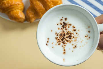 croissant and hot milk on a yellow background, top view,breakfast
