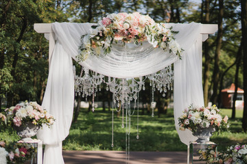 Coziness and style. Modern event design. Lounge zone and european traditional wedding ceremony decoration outdoors in the restaurant before the reception.