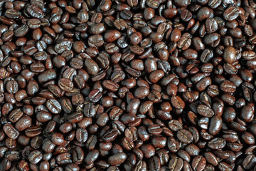 Brown roasted coffee beans, seed on dark background.
