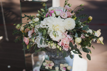 Coziness and style. Modern event design. Lounge zone and european traditional wedding ceremony decoration outdoors in the restaurant before the reception.