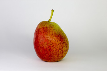 green-red pear on white background, close-up, copy space