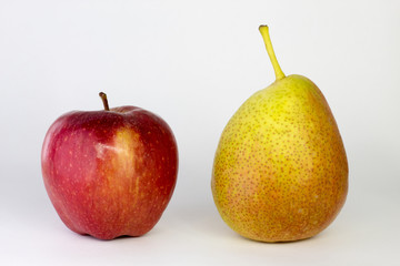 apple and pear on a white background, close-up
