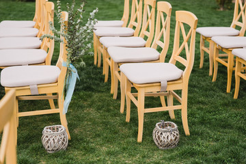 Coziness and style. Modern event design. Lounge zone and european traditional wedding ceremony decoration outdoors in the restaurant before the reception.