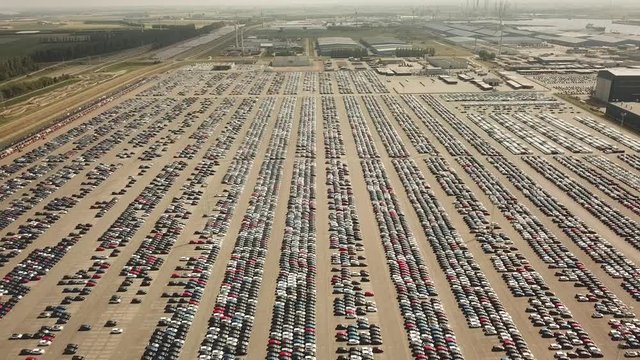 Many new and occasion Cars on a huge parking lot waiting for shipment, Aerial