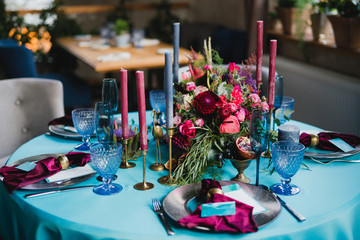 Coziness and style. Modern event design. Table setting at wedding reception. Floral compositions...