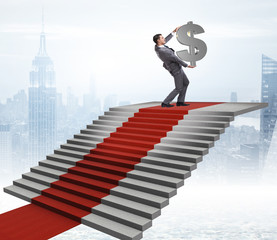 Young businessman climbing stairs and red carpet