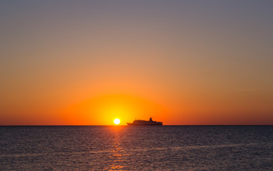 Fototapeta na wymiar Silhouette of a tourist ship at sunset