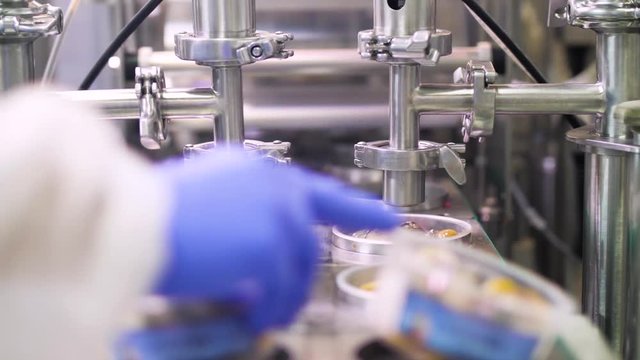 Automatic Oil Feeling on a Smoked Fish Assembly Line.