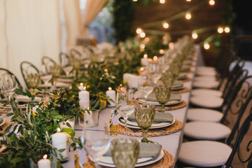 Coziness and style. Modern event design. Table setting at wedding reception. Floral compositions...