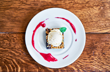 Brownie Sundae with a Scoop of Vanilla Ice Cream and Berry Sauce