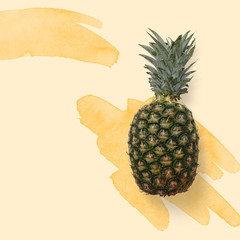 Yellow pineapple top view on the watercolor splash. Exotic fruit flatlay
