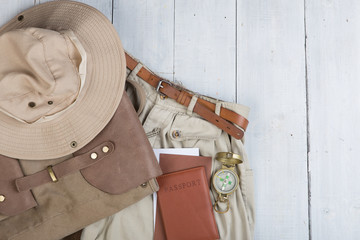 Prepare for journey in safari style, hiking and backpacker - accessories and travel items, packing clothes in backpack: backpack, passport, tickets, hat © veranoverde