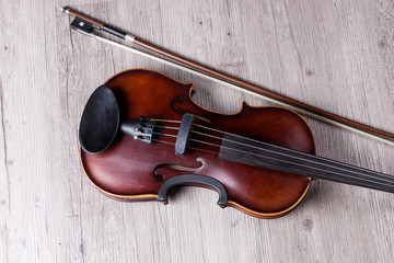 Fototapeta na wymiar Classical violin isolated on wooden background. Studio shot of old violin. Classical musical instrument