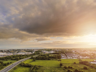 Sunset sky over Galway city, Aerial view, cloudy sky, Atlantic ocean and Burren mountains in the background.