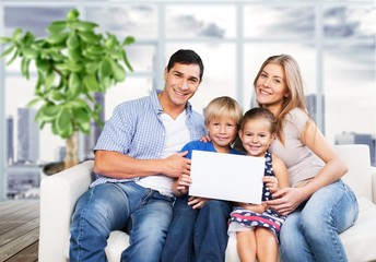 Young  family at home smiling at camera