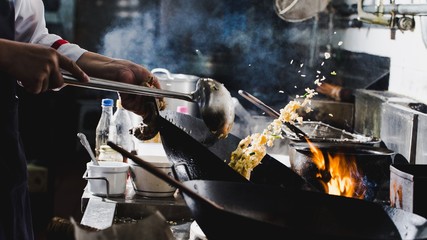 Fototapeta na wymiar Chef stir fry cooking