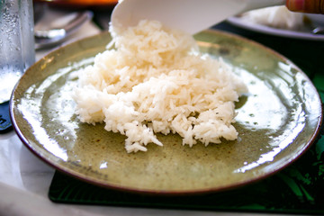 Cooked plain on traditional light green dish on marble table background