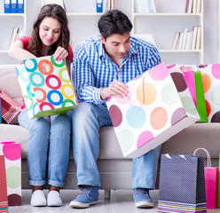 Young pair after shopping with many bags