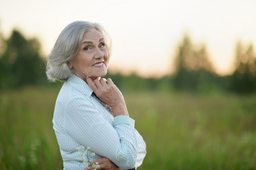 Portrait of happy senior beautiful woman posing in spring park