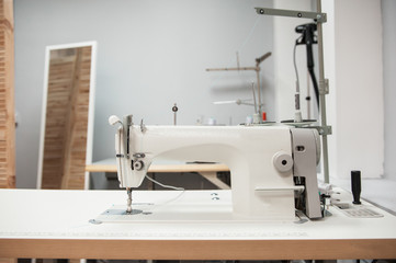 Industrial sewing machine in tailor's workshop
