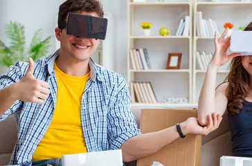 Young family playing games with virtual reality glasses