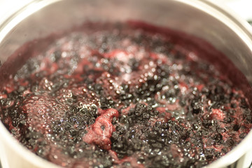 Close-up view of boiling blueberries. Cooking blueberry jam.