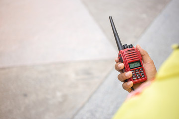 Selective focus of the Security guard uses radio communication for facilitate traffic. Traffic...