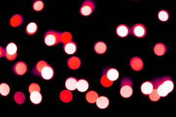 Unfocused abstract red bokeh on black background. defocused and blurred many round light